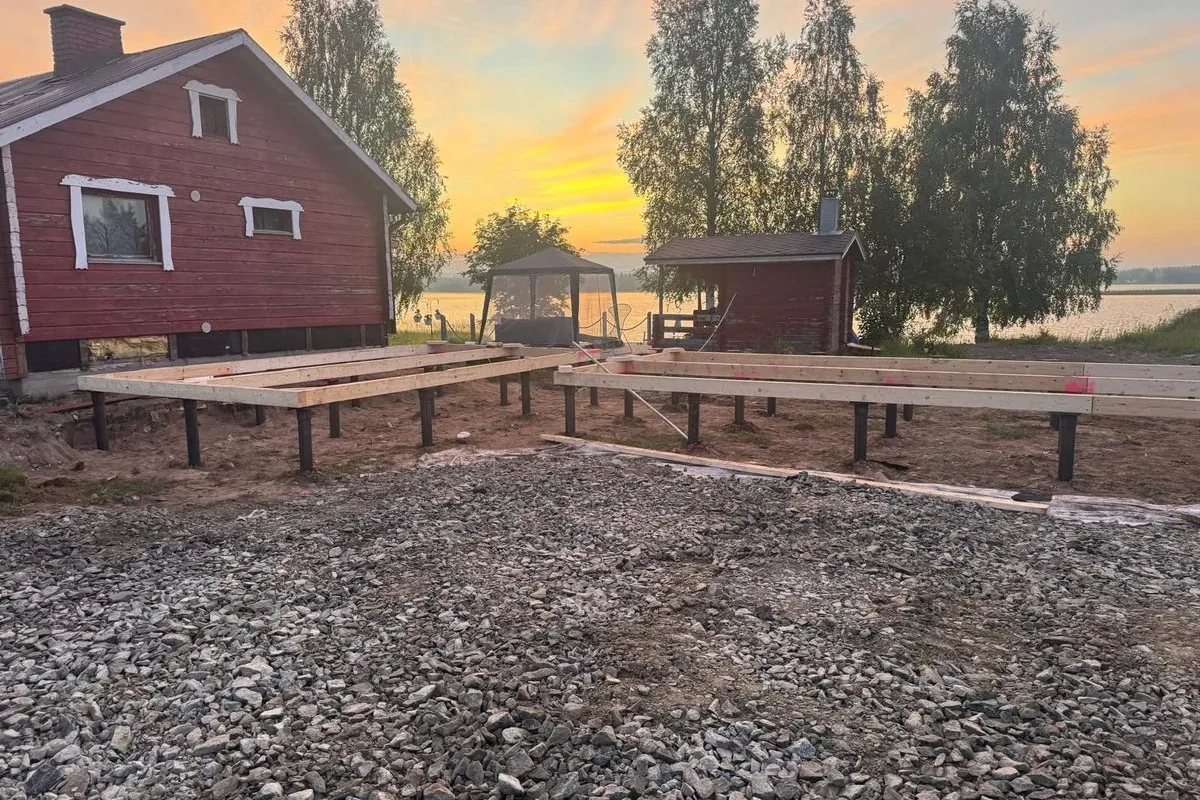 Steel beams on adjustable pile head plates at sunset, northern Finland