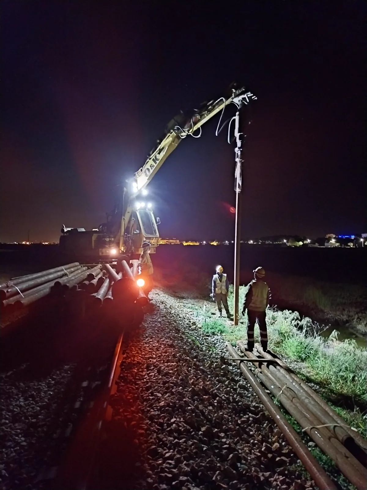Night-time helical pile installation next to the track on the Algarve Line